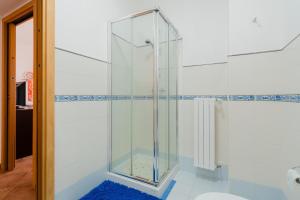 a glass shower in a bathroom with a blue rug at Stella Maris a Porto Cesareo in Porto Cesareo +26 photos