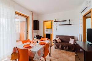 a living room with a table and a couch at Stella Maris a Porto Cesareo in Porto Cesareo