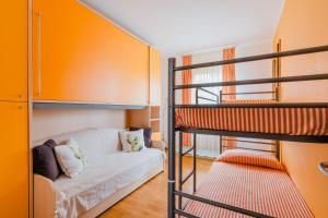 a living room with a bunk bed and a couch at Stella Maris a Porto Cesareo in Porto Cesareo