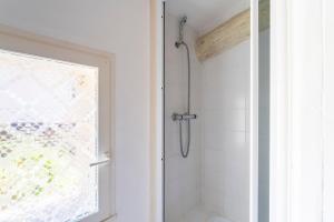 a bathroom with a shower with a glass door at Mazet de Cabrières Gordes, Clim in Cabrières-dʼAvignon