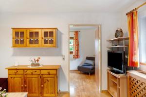 a living room with a television and a couch at Appartment Stockeben in Niederau