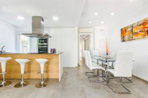 a kitchen and dining room with a table and chairs at Playamar in Alcudia