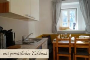 a kitchen with a sink and a table with chairs at Priestereck in Obernberg am Brenner +2 photos