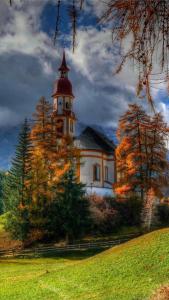 a building with a tower on top of a hill at Priestereck in Obernberg am Brenner