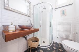 a bathroom with a sink and a glass shower at La Casa Bianca in Lipari +28 photos