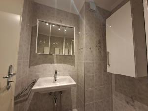a bathroom with a sink and a mirror at App 17 Haus Nordland in Sylt +7 photos