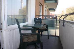 a small table and two chairs on a balcony at App 17 Haus Nordland in Sylt