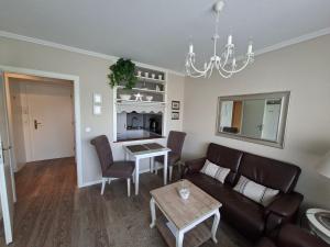 a living room with a couch and a table at App 17 Haus Nordland in Sylt