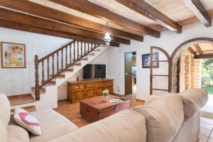 a living room with a couch and a tv at Can Llobera in Pollença