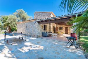 a patio with a ping pong table in front of a house at Can Llobera in Pollença