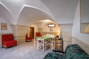 a living room with a table and chairs and a room at Casa dell'Angelo in Muro Leccese +15 photos