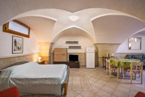 a bedroom with a bed and a table in a room at Casa dell'Angelo in Muro Leccese