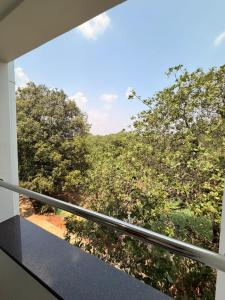 a view from a balcony with trees in the background at Ascent Eco Resorts & Conventions in Rājānagaram