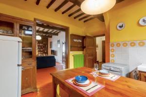 a kitchen with a wooden table with plates on it at Il Tuo Posto A Greve In Chianti in Greve in Chianti