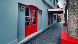 a red door on the side of a building at Hotel Windsor Mendoza in Mendoza