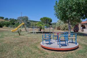 a playground with blue chairs and a slide at Podere Chinco - Gavorrano in Gavorrano