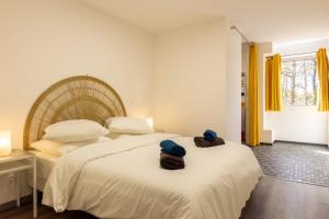 a bedroom with two beds with hats on the bed at L'ilot Narossais - Conciergerieland in Narrosse +51 photos