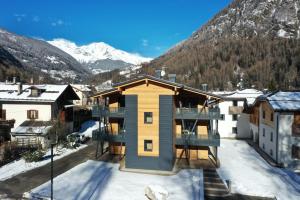 a house in the mountains with snow on the ground at Luxury Ossana in Fucine