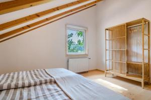 a bedroom with a bed and a window at Enjoy mal - Apartments in Stockach