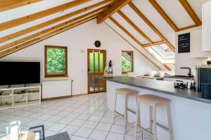 a kitchen with a large counter and stools at Enjoy mal - Apartments in Stockach