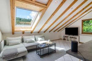 a living room with a couch and a tv at Enjoy mal - Apartments in Stockach