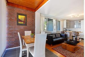 a kitchen and living room with a brick wall at Balingen Apartment in Balingen