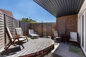 a patio with chairs and a table on a wooden deck at Balingen Apartment in Balingen