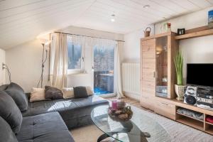 a living room with a couch and a glass table at Villa Sonnenwinkel in Todtmoos