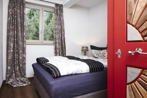 a bedroom with a bed and a red door at Panorama in Ibach +17 photos