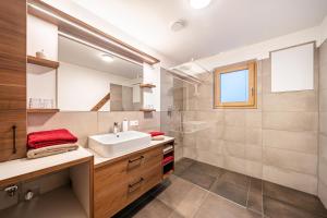 a bathroom with a sink and a mirror at Apartment Klara in Meltina +12 photos