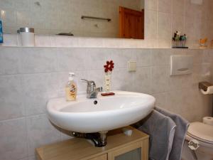 a bathroom with a white sink and a toilet at Ferienwohnung Linder in Schömberg +17 photos
