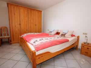 a bedroom with a bed with a wooden cabinet at Ferienwohnung Linder in Schömberg