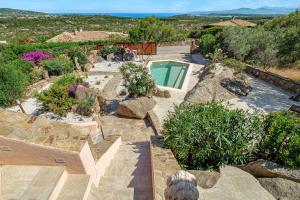 an image of a garden with a swimming pool at Villa Leone con piscina privata in Punta Molara