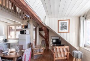a kitchen and dining room with a table and chairs at Chalet Arclosan - Saint-Ferréol in Saint-Ferréol