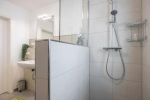 a bathroom with a shower and a sink at Kroge Apartment in Uelzen +18 photos