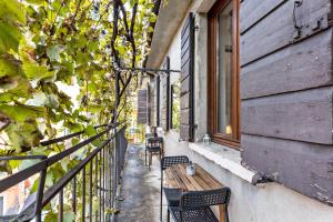 a balcony with two chairs and a wooden table at la vigna del Vescovo in Verona