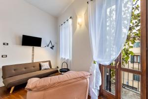 a living room with a couch and a window at la vigna del Vescovo in Verona