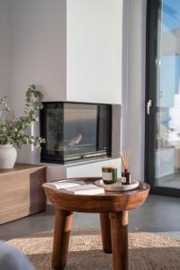 a wooden coffee table in a living room with a tv at Nimbus Villas in Kalamitsi