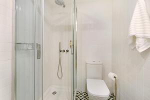a white bathroom with a shower and a toilet at Casa de São Pedro Sintra in Sintra +13 photos