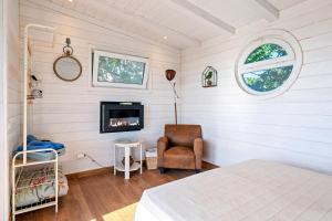 a bedroom with a bed and a fireplace at Casa Arbol in Camarles +23 photos