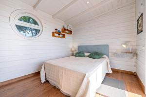 a bedroom with a bed in a room with a window at Casa Arbol in Camarles