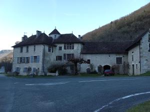 an old house with a car parked in front of it at Room - Les loups bleus in Rossillon +16 photos