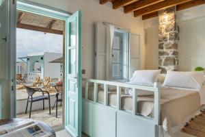a bedroom with a bed and a balcony at Santanna Suites in Patmos +201 photos