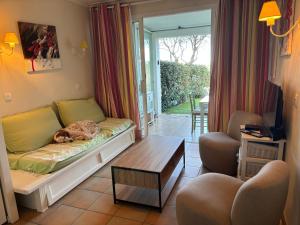 a cat sleeping on a couch in a living room at Restanques de Saint Tropez - arums in Grimaud