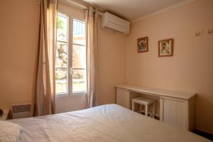 a bedroom with a bed and a window at Restanques de Saint Tropez - arums in Grimaud