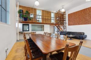 a dining room and living room with a wooden table and chairs at Ferienwohnung Atelier in Schopfheim