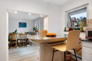 a kitchen and dining room with a table and chairs at Haus Schliengen in Schliengen