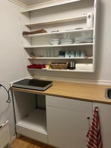 a kitchen with an open refrigerator with dishes in it at Mysig Stuga in Sveg