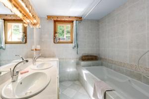a bathroom with two sinks and a tub at Lupins in Valloire +14 photos