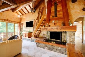 a living room with a fireplace in a log cabin at Lupins in Valloire